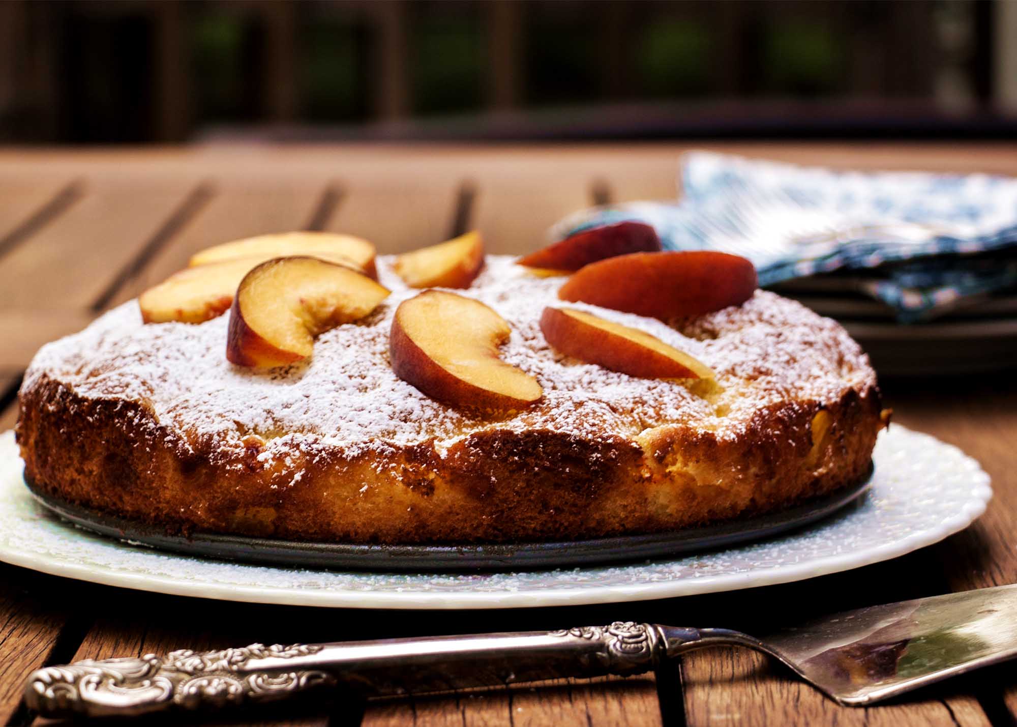 Summertime Peach Cake - Peaches, a hint of orange, and a cake which goes together in a snap and keeps for days | justalittlebitofbacon.com