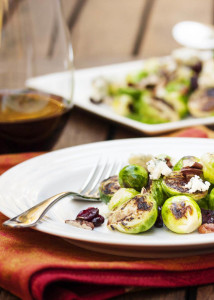 Blue Cheese and Brussels Sprout Salad - Pan roasted Brussels sprouts are paired with blue cheese and tossed with a tangy mustard vinaigrette in this fast and flavorful salad. | justalittlebitofbacon.com