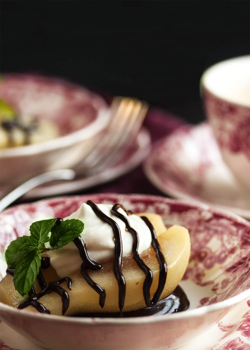 Poached Pears with Mascarpone Cream - These pears are poached in a spiced white wine syrup and then filled with mascarpone whipped cream and finished with a drizzle of bittersweet chocolate sauce. A wonderful way to end a holiday meal! | justalittlebitofbacon.com