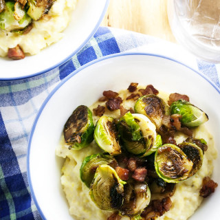 Creamy Polenta Topped with Brussels Sprouts and Pancetta - Pan roasted brussel sprouts, crispy pancetta, and creamy, cheesy polenta all in one bowl? That's the definition of yummy. | justalittlebitofbacon.com