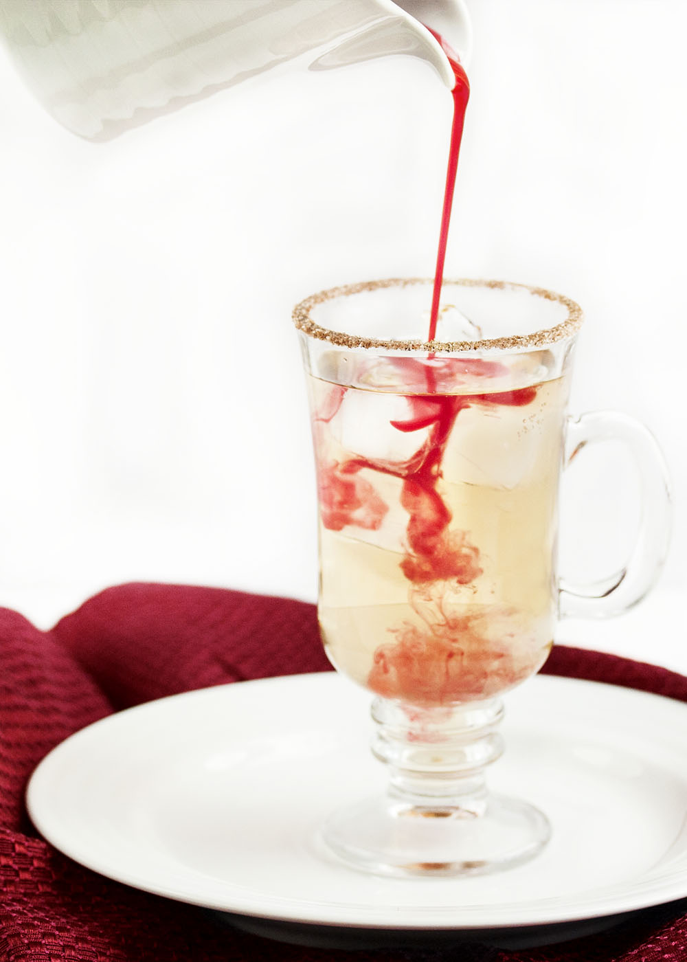 Cranberry Ginger Fizz Cocktail - This cranberry cocktail is an easy and tasty way to celebrate Thanksgiving and the winter holiday season. Just whip up a batch of the yummy cranberry syrup ahead of time and you are good to go. | justalittlebitofbacon.com