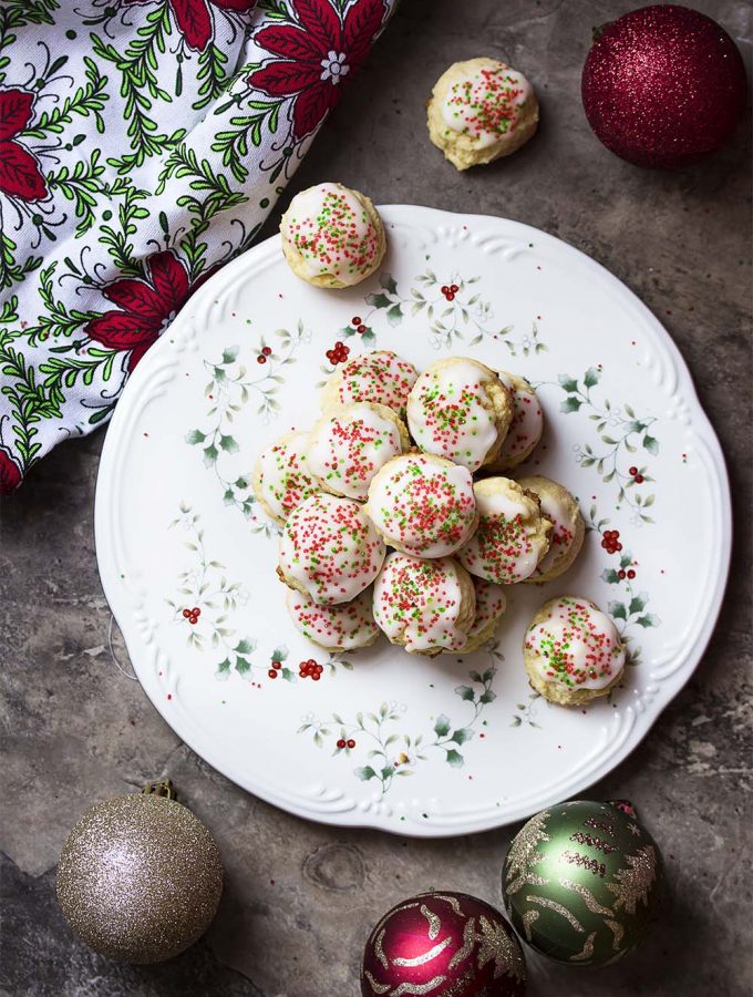 For the best holiday cookies, make my easy Italian lemon ricotta cookies! These traditional cookies are soft and tender and topped with a lemon glaze and colorful sprinkles. Great for Christmas, Easter, and any other holiday or occasion. | justalittlebitofbacon.com #italianrecipes #italiancookies #cookierecipes #christmasrecipes #holidayrecipes #easterrecipes #cookies