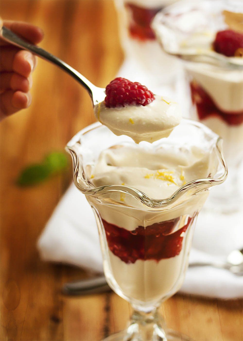 Raspberry Parfait with Ricotta Cream - In the mood for a healthy dessert that tastes like an indulgence? Creamy, lightly sweetened ricotta is layered with raspberries in this very easy and pretty parfait. | justalittlebitofbacon.com