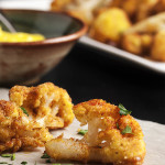 Pan Fried Spanish Cauliflower Tapas - These breaded fried cauliflower bites are a simple and tasty tapas dish you should make at your next get-together! Just a quick dunking in egg and breadcrumbs and a minute in a skillet and you are all done. Can be made ahead and reheated! | justalittlebitofbacon.com