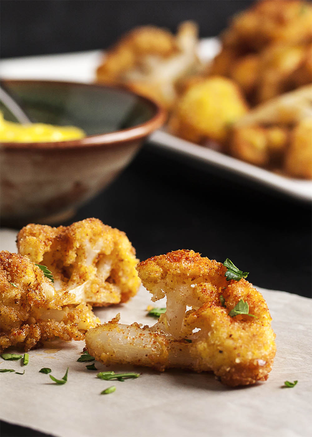 Pan Fried Spanish Cauliflower Tapas - These breaded fried cauliflower bites are a simple and tasty tapas dish you should make at your next get-together! Just a quick dunking in egg and breadcrumbs and a minute in a skillet and you are all done. Can be made ahead and reheated! | justalittlebitofbacon.com