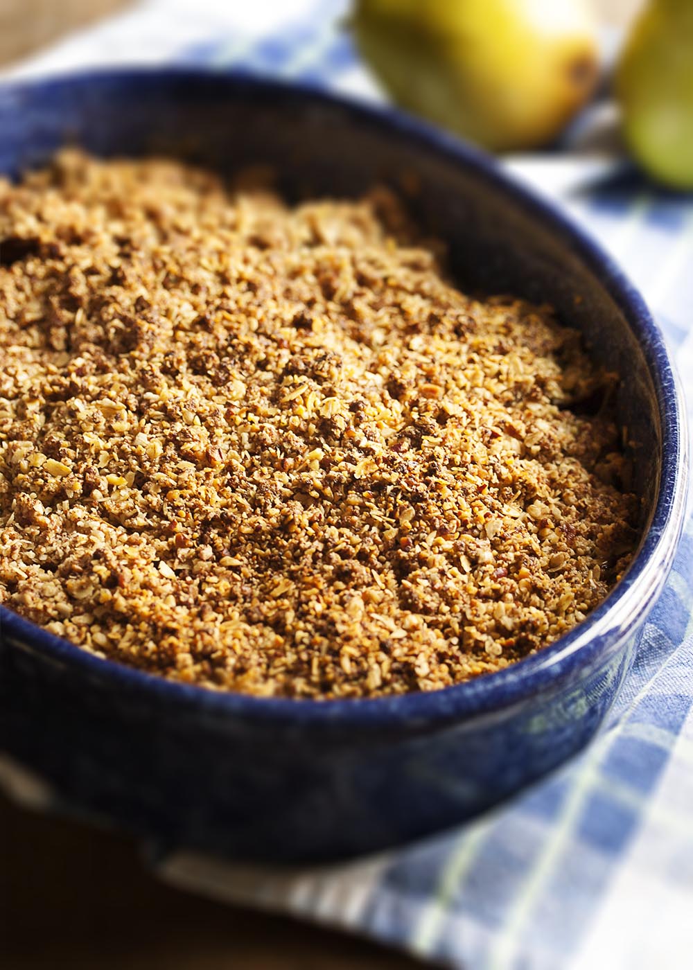 Gluten-Free Pear Ginger Crumble - Ripe pears and freshly grated ginger are topped with a nut and oat streusel in this lightly sweetened, gluten-free crumble. With no peeling necessary since the pears are sliced so thin! | justalittlebitofbacon.com