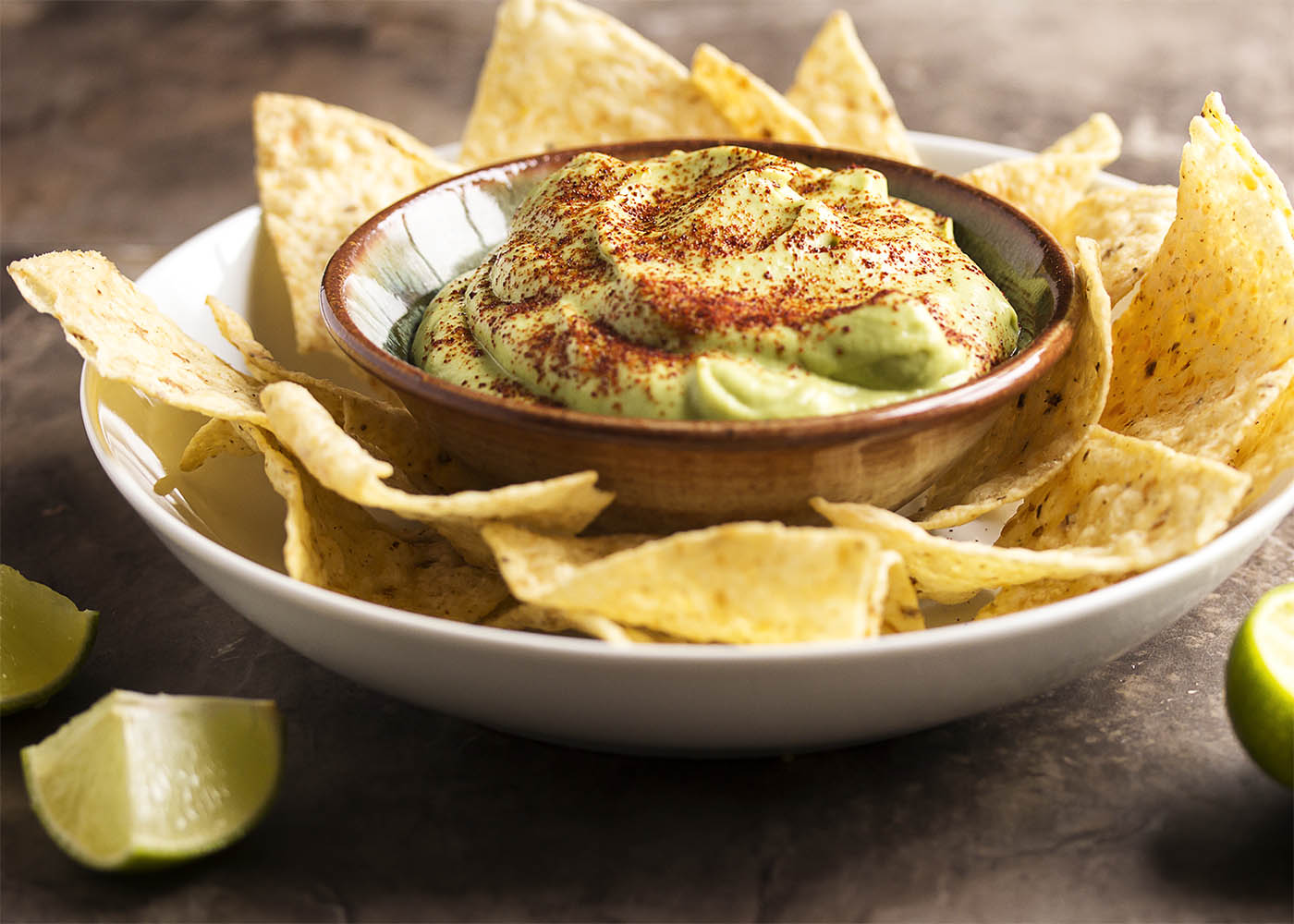 Tangy Lime Avocado Crema - Avocados are pureed with lime juice and a touch of sour cream in this Avocado Crema. Great as a taco topping, a sauce, or a dip! | justalittlebitofbacon.com