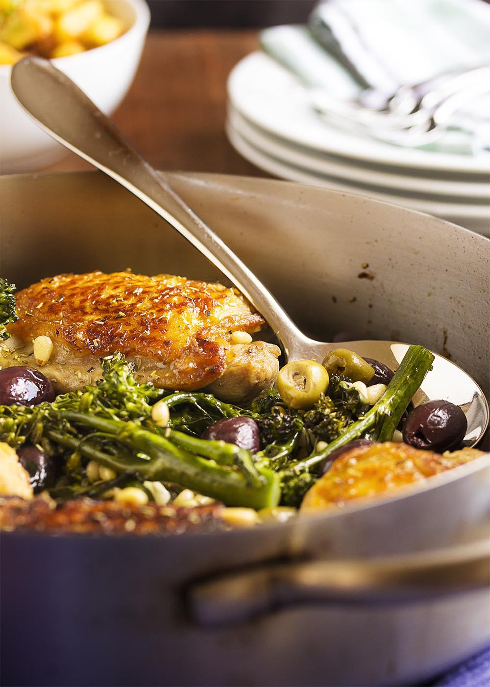 Pan Roasted Chicken Thighs with Olives and Pine Nuts - The crispy, crackling skin and juicy, flavorful meat on these chicken thighs is paired with salty olives and creamy pine nuts in this easy main dish. Add a bunch of broccolini, and you have dinner! | justalittlebitofbacon.com