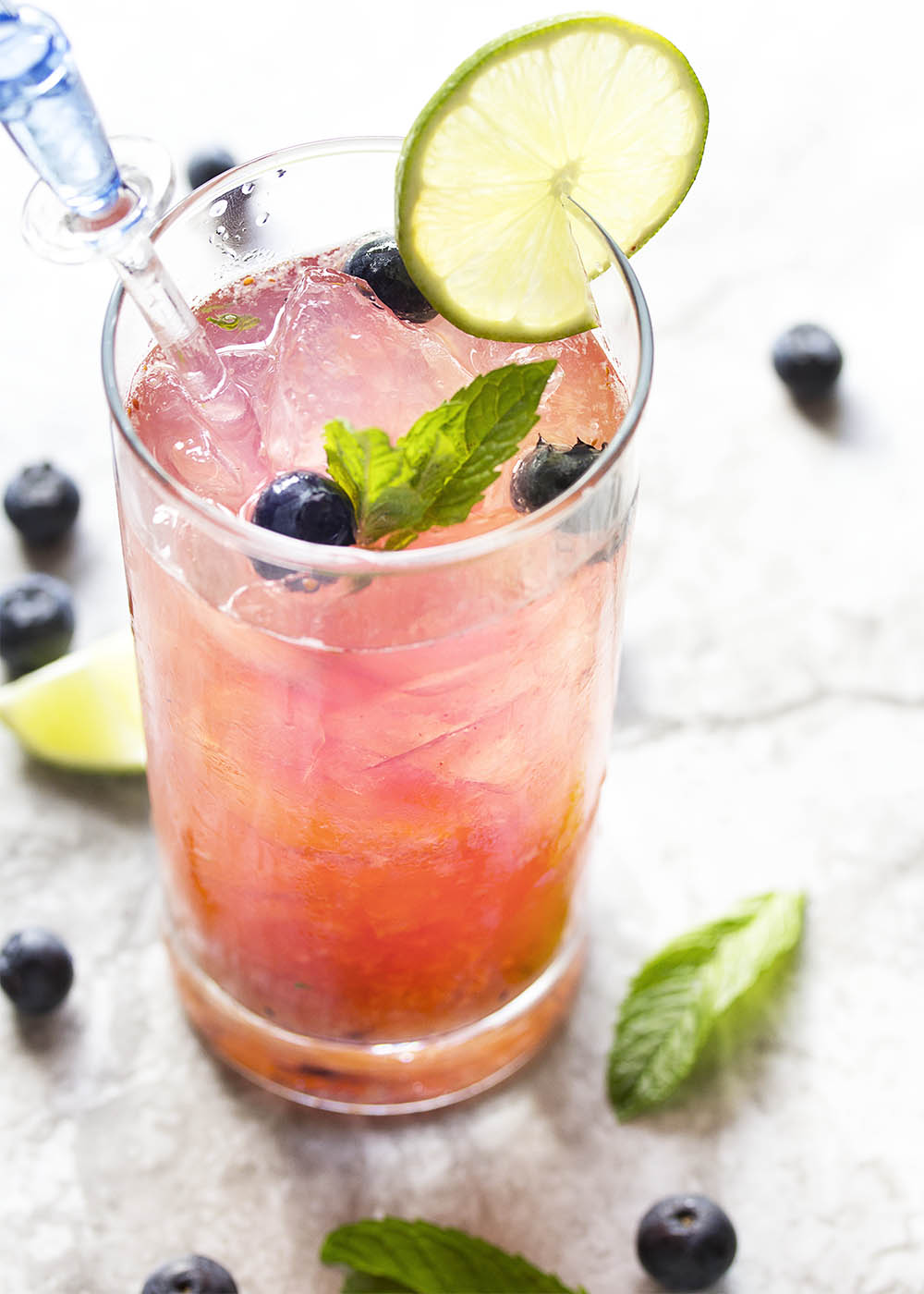 Fresh Blueberry Mojito - This blueberry mojito is full of fresh blueberry and mint flavor, and is an easy and refreshing summer drink perfect for sipping out of a straw. Great for cookouts or a warm evening on your deck! | justalittlebitofbacon.com