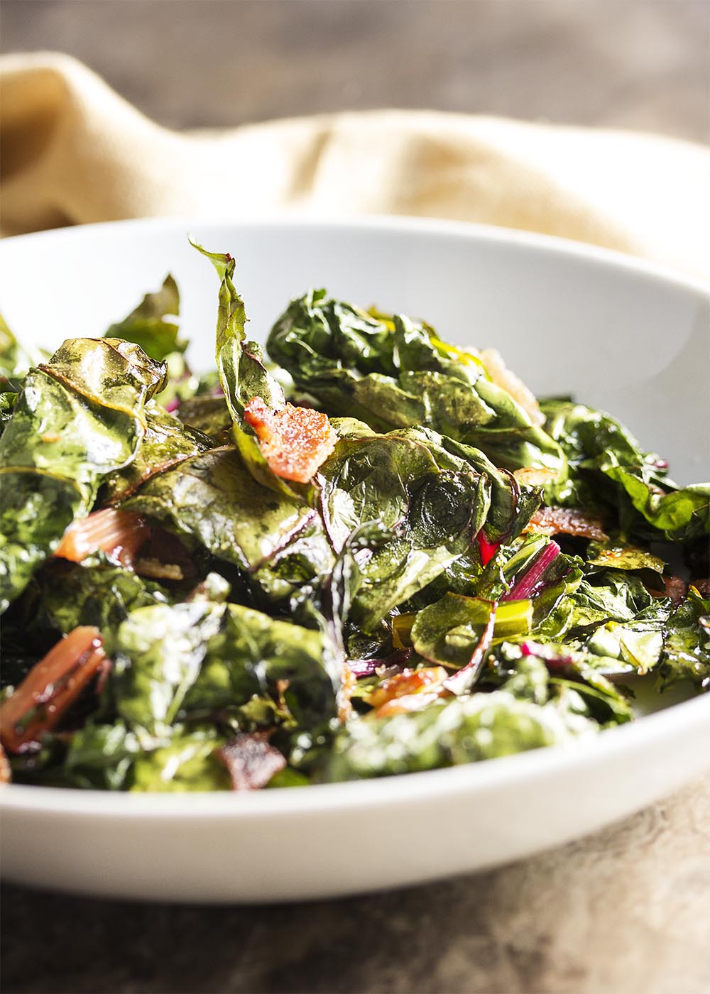 Swiss Chard Chips - Don't know what to do with chard? Family won't eat it? Try this recipe where Swiss chard leaves are tossed in bacon fat and baked to crispness to make addictively yummy chard chips. | justalittlebitofbacon.com