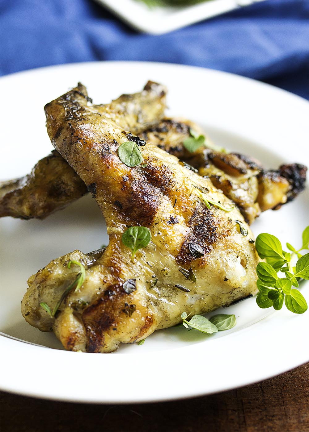 Herb Marinated Grilled Chicken Wings - Grilled chicken wings take on Italian flavors when they are marinated in fresh herbs and lemon and then grilled to crispy perfection. Great for cookouts! | justalittlebitofbacon.com