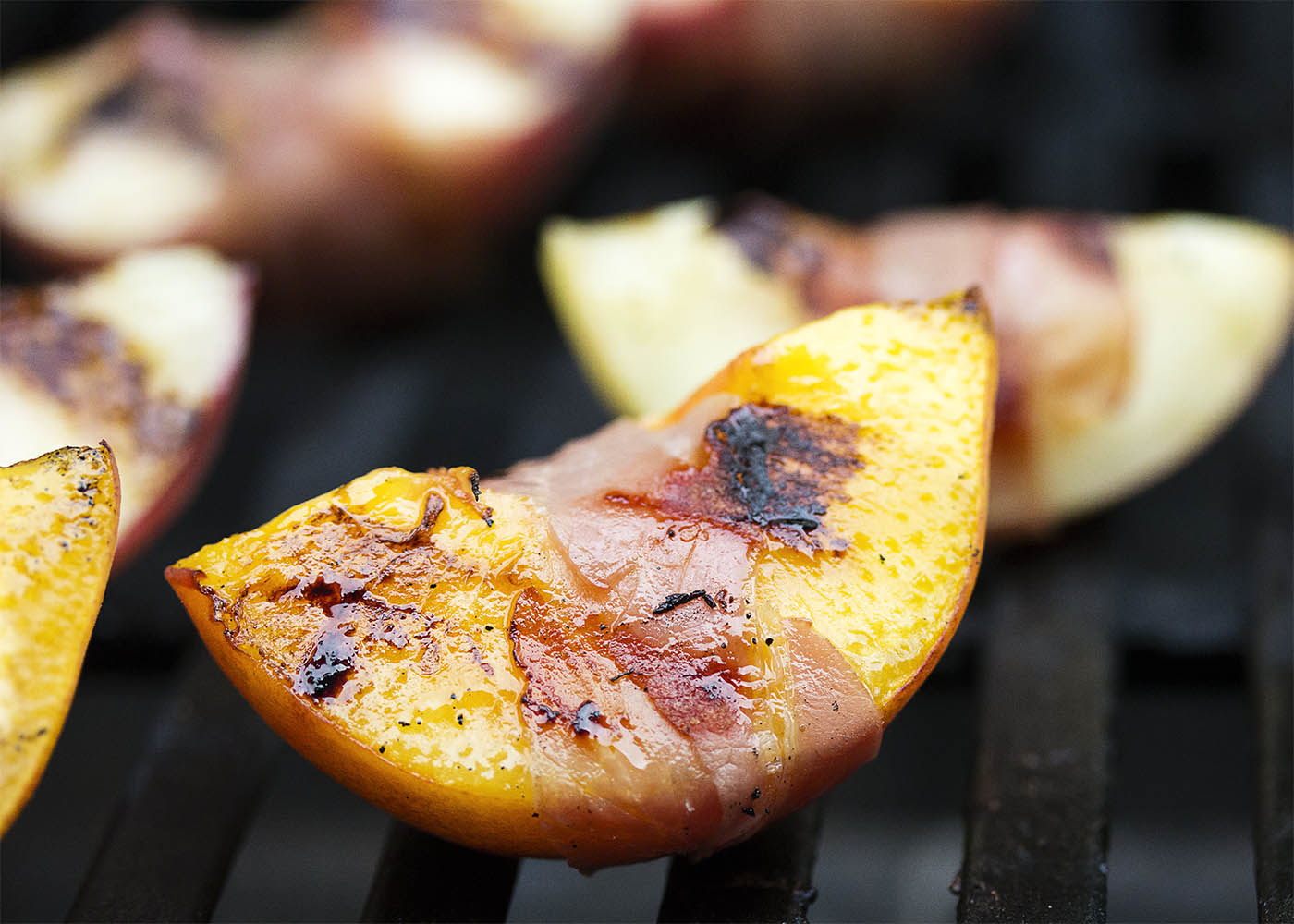 Balsamic Grilled Peaches with Burrata and Prosciutto - Sweet, salty, creamy, and tart combine in this recipe to create a recipe full of bold flavors. Juicy, sweet peaches are wrapped in prosciutto and seared on the grill, then drizzled with balsamic vinegar and paired with burrata. Wonderful as an appetizer or as a side dish. | justalittlebitofbacon.com