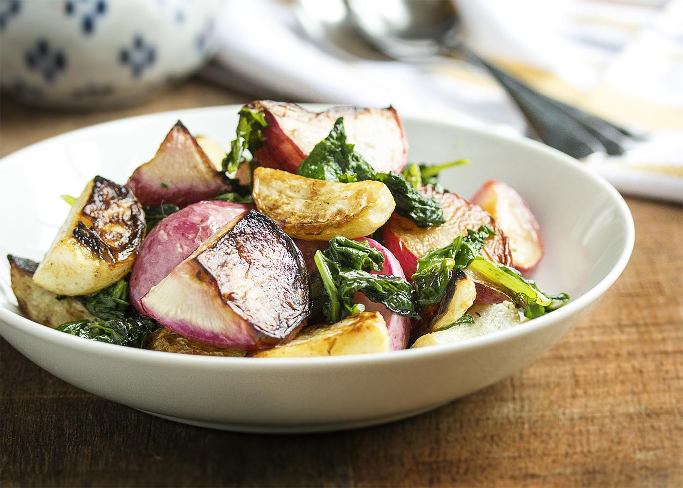 Roasted Turnips and Radishes - Sweet Hakurei turnips and young radishes are tossed with olive oil and roasted with their greens in this simple and satisfying side dish. | justalittlebitofbacon.com