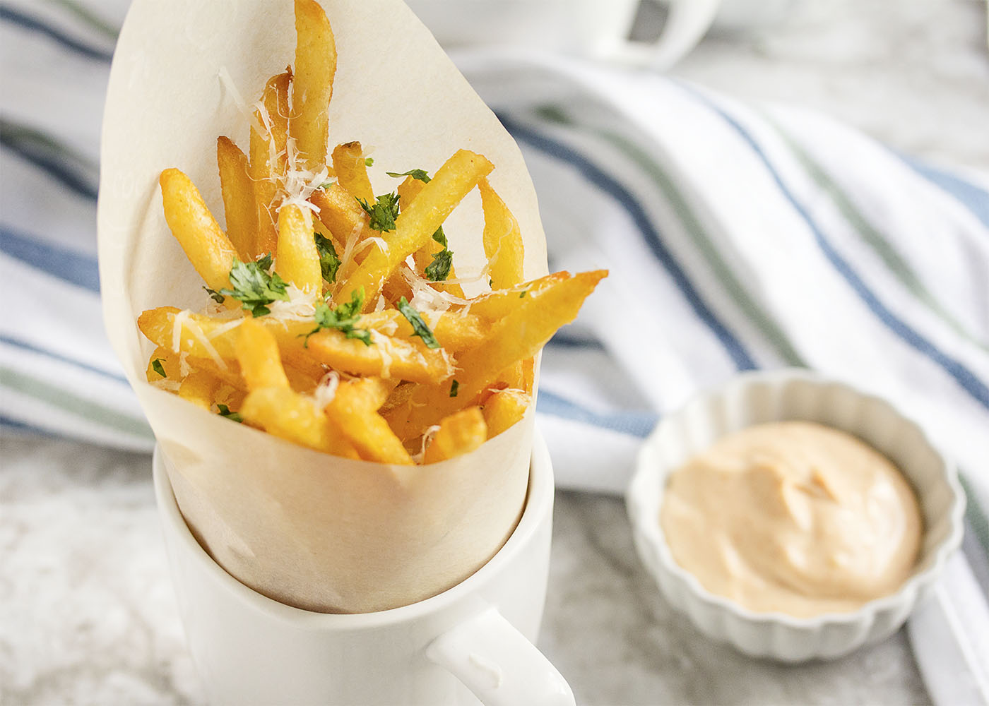 Parmesan Truffle Fries - Use frozen, bagged fries to have tasty truffle fries, covered in truffle oil, parmesan, and parsley on the table in less than 15 minutes. | justalittlebitofbacon.com