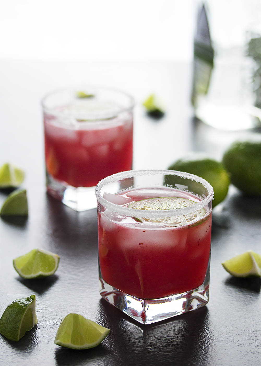 Fresh cranberry sauce is the secret to these intensely flavored tart-sweet fresh cranberry margaritas. Make them by the glass or in a pitcher for parties. | justalittlebitofbacon.com