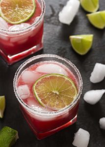 Fresh cranberry sauce is the secret to these intensely flavored tart-sweet fresh cranberry margaritas. Make them by the glass or in a pitcher for parties. | justalittlebitofbacon.com