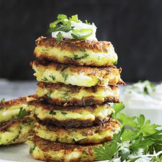 Shredded zucchini, salty feta, rice flour, and fresh parsley are featured in these vegetarian, gluten-free zucchini fritters. | justalittlebitofbacon.com