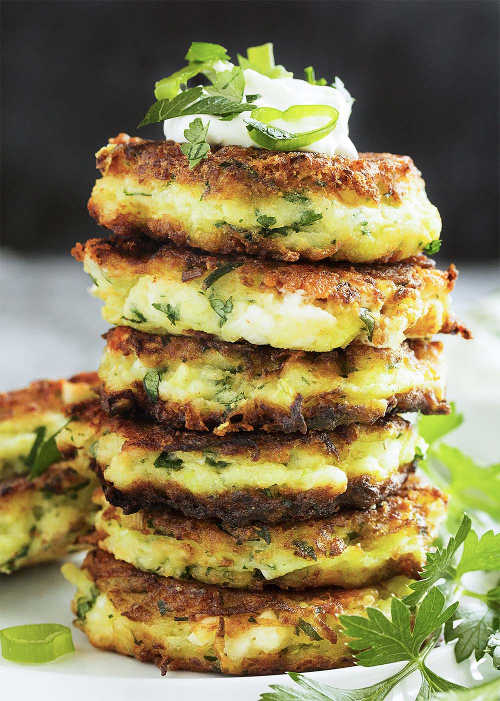 Shredded zucchini, salty feta, rice flour, and fresh parsley are featured in these vegetarian, gluten-free zucchini fritters. | justalittlebitofbacon.com