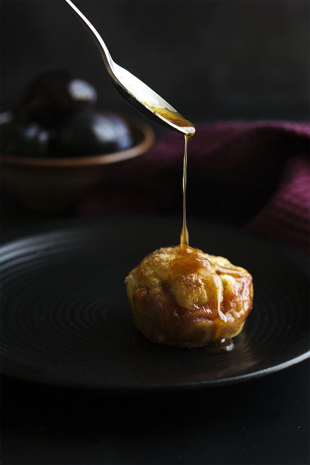 Pull out your muffin tin for easy clean up and wrap plum slices and spiced honey in puff pastry to make these puff pastry plum tarts. Bake until they are puffed and golden, then drizzle with a little more spiced honey, and serve with mascarpone whipped cream. | justalittlebitofbacon.com