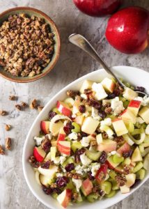 Maple glazed pecans, blue cheese, and diced apples combine with dried cranberries and sliced celery in this fall harvest salad. Great for weeknight dinners and a wonderful side for Thanksgiving. | justalittlebitofbacon.com