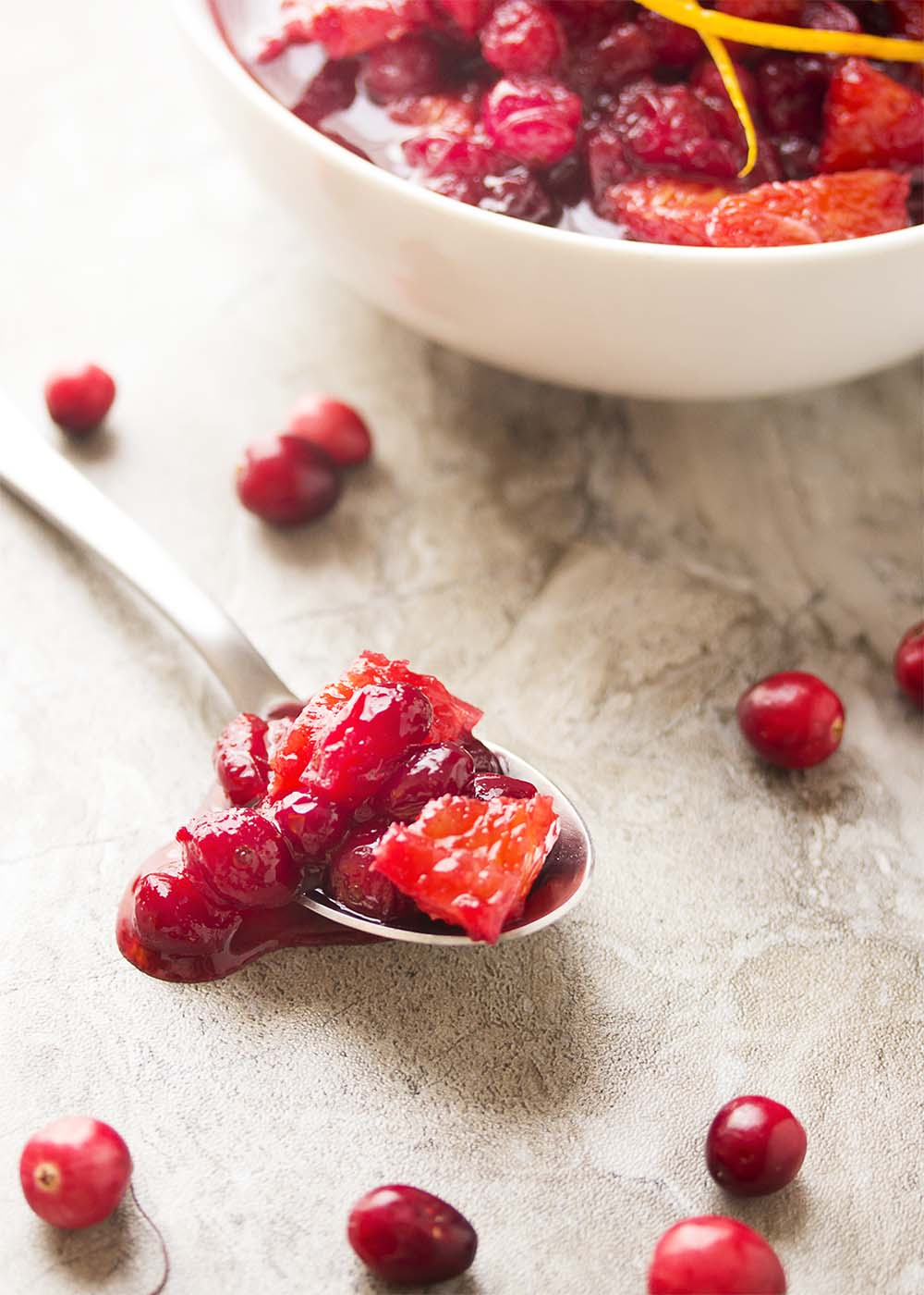 Check out this easy recipe for homemade cranberry sauce! Fresh cranberries are simmered in port wine and mixed with diced oranges to make a great Thanksgiving recipe for Cranberry Port Orange Sauce. | justalittlebitofbacon.com