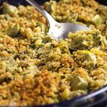 Want to know how to cook baby artichokes? In this easy recipe baby artichokes are trimmed up, topped with parsleyed bread crumbs and made into a baked artichoke gratin. Great holiday dish! | justalittlebitofbacon.com