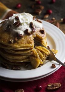 Light, fluffy and full of mashed sweet potatoes, these sweet potato buttermilk pancakes are a tasty and tangy way to start your day. | justalittlebitofbacon.com