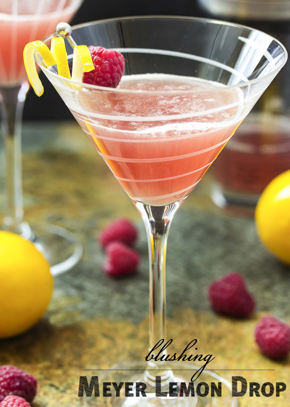 This blushing meyer lemon drop is a martini with a twist! Vodka is mixed with floral Meyer lemon juice and spiked with a bit of raspberry liqueur to make a great sweet and sour cocktail. | justalittlebitofbacon.com