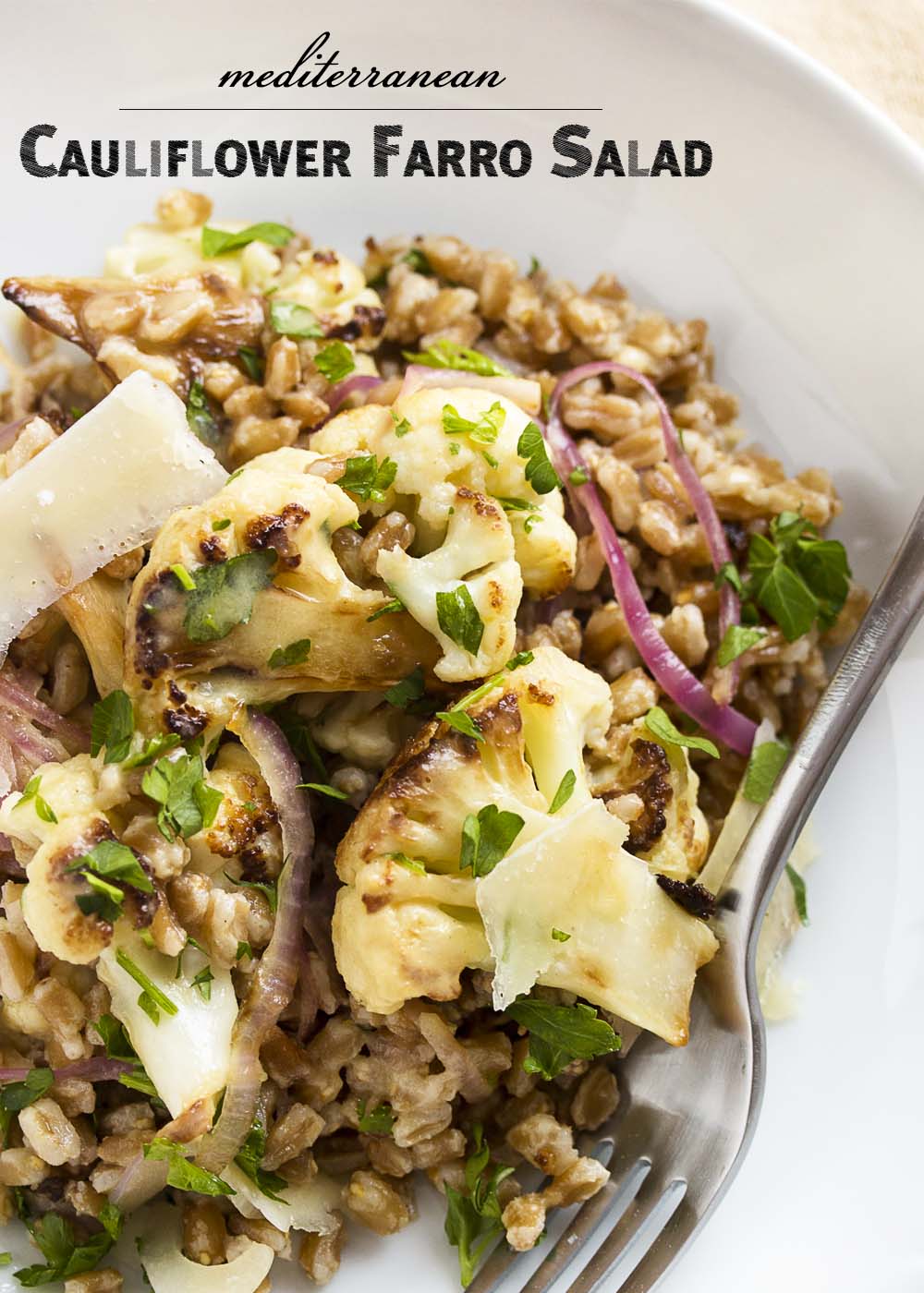 This warm Mediterranean farro salad is tossed with pan roasted cauliflower and creamy tahini lemon dressing to make a great winter salad. | justalittlebitofbacon.com