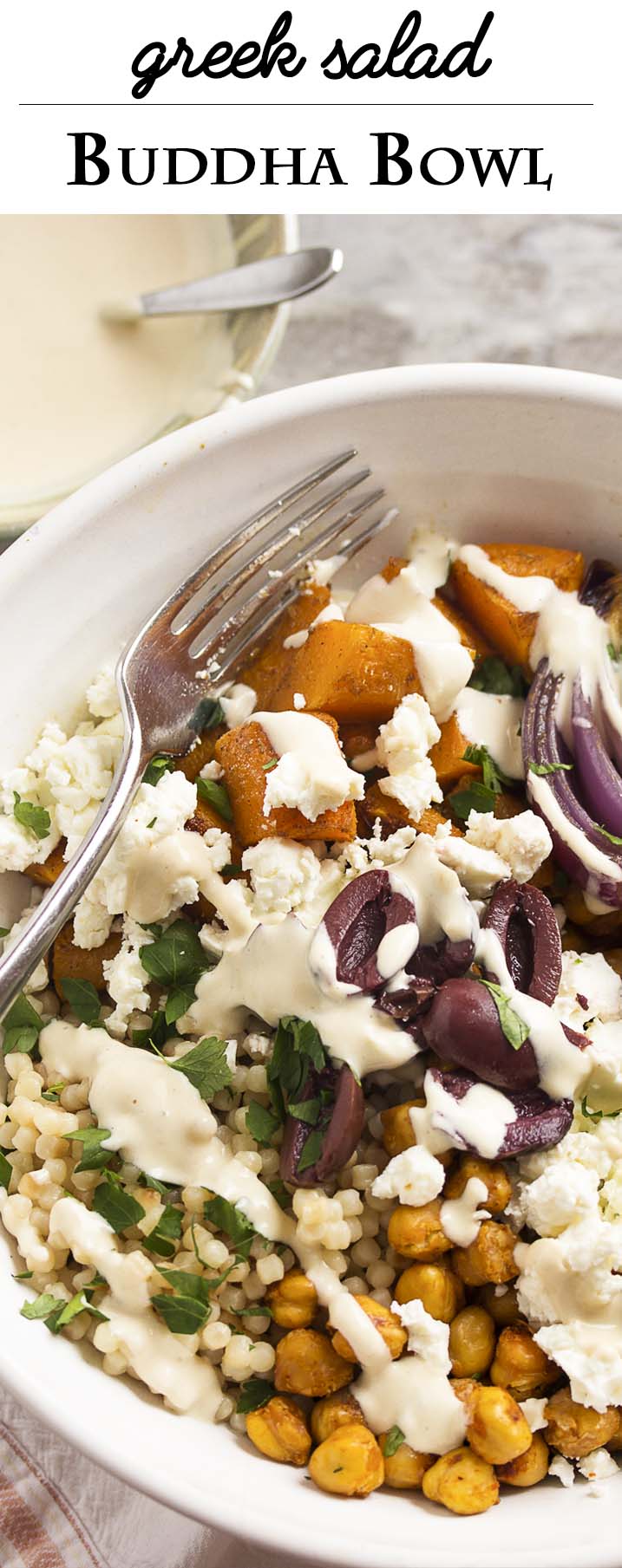 Turn Greek salad into a satisfying one bowl dinner with this Greek Buddha Bowl! It's full of chickpeas, roasted squash, pearl couscous, feta, and olives all over a bed of spinach and drizzled with a yogurt, tahini dressing. | justalittlebitofbacon.com
