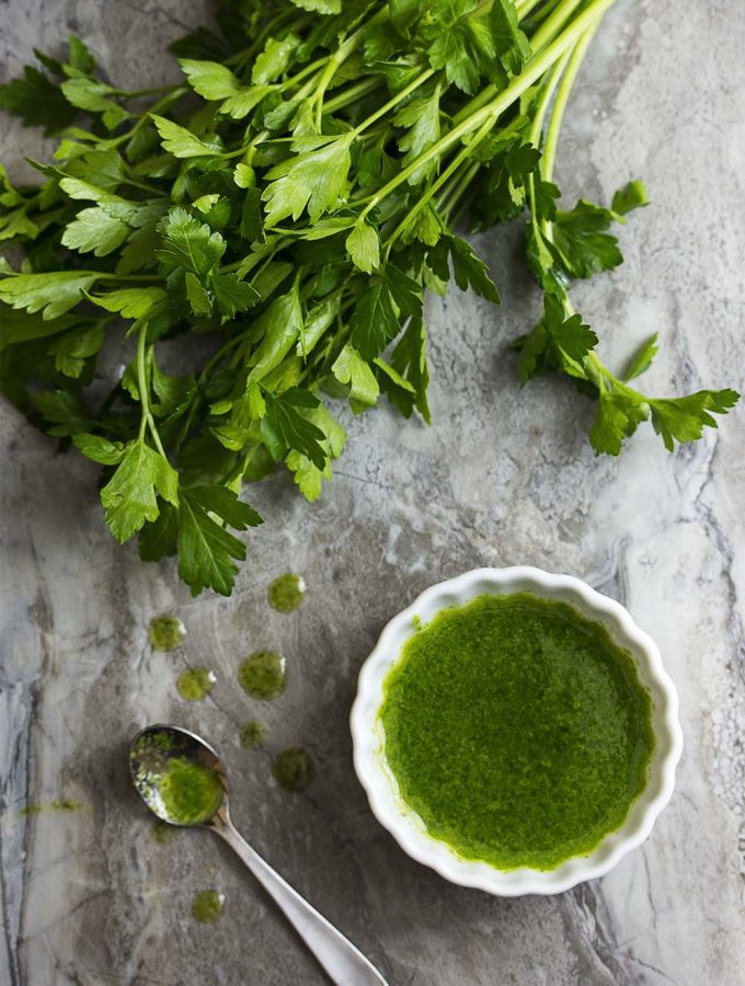 This parsley infused olive oil is a quick condiment which is wonderful drizzled over soups, bruschetta, grilled foods, and more! | justalittlebitofbacon.com