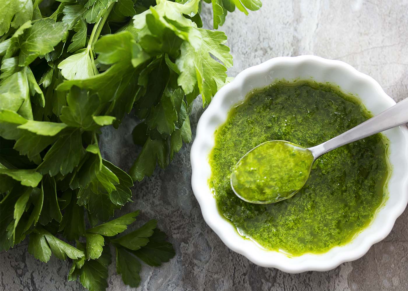 This parsley infused olive oil is a quick condiment which is wonderful drizzled over soups, bruschetta, grilled foods, and more! | justalittlebitofbacon.com
