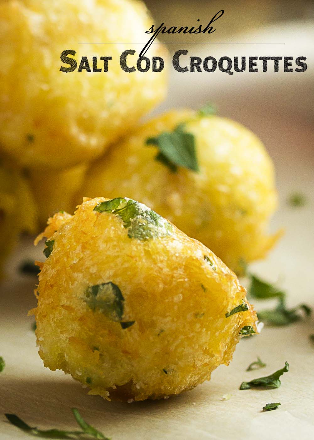 Light, fluffy, and crispy! These Spanish salt cod croquettes with aioli are bite-sized fish fritters perfect for a tapas party. | justalittlebitofbacon.com
