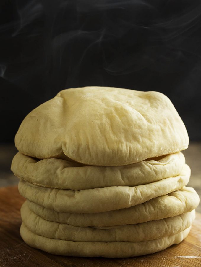 Homemade Greek Pita Bread isn't hard to make! You simply need a hot oven, fresh yeast, and a few tricks to make yummy pocket bread. | justalittlebitofbacon.com