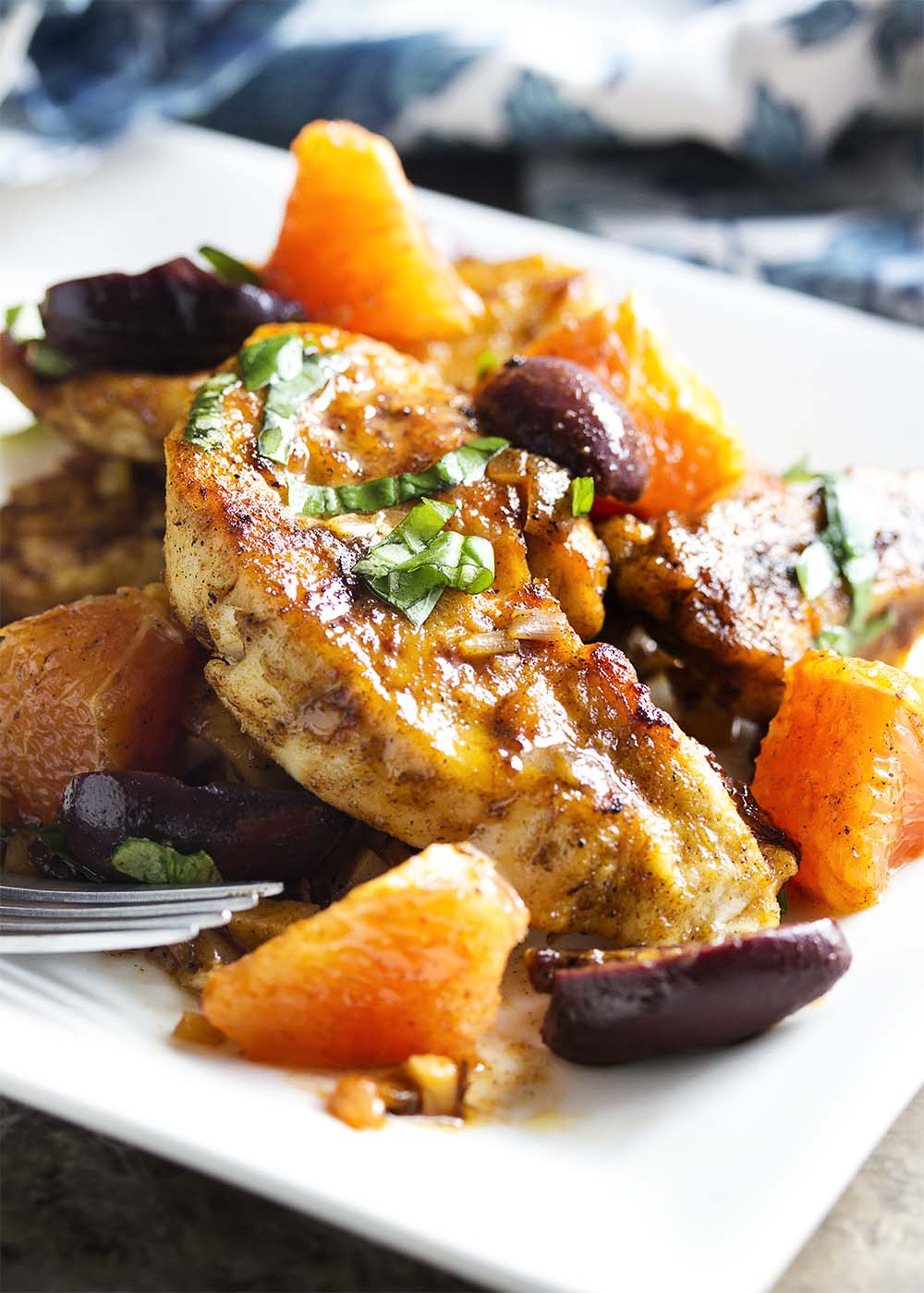 Easy and quick! This Mediterranean chicken skillet combines tender chicken breast with olives and oranges for a spicy/sweet dinner recipe. Great with roasted potatoes or over rice. | justalittlebitofbacon.com