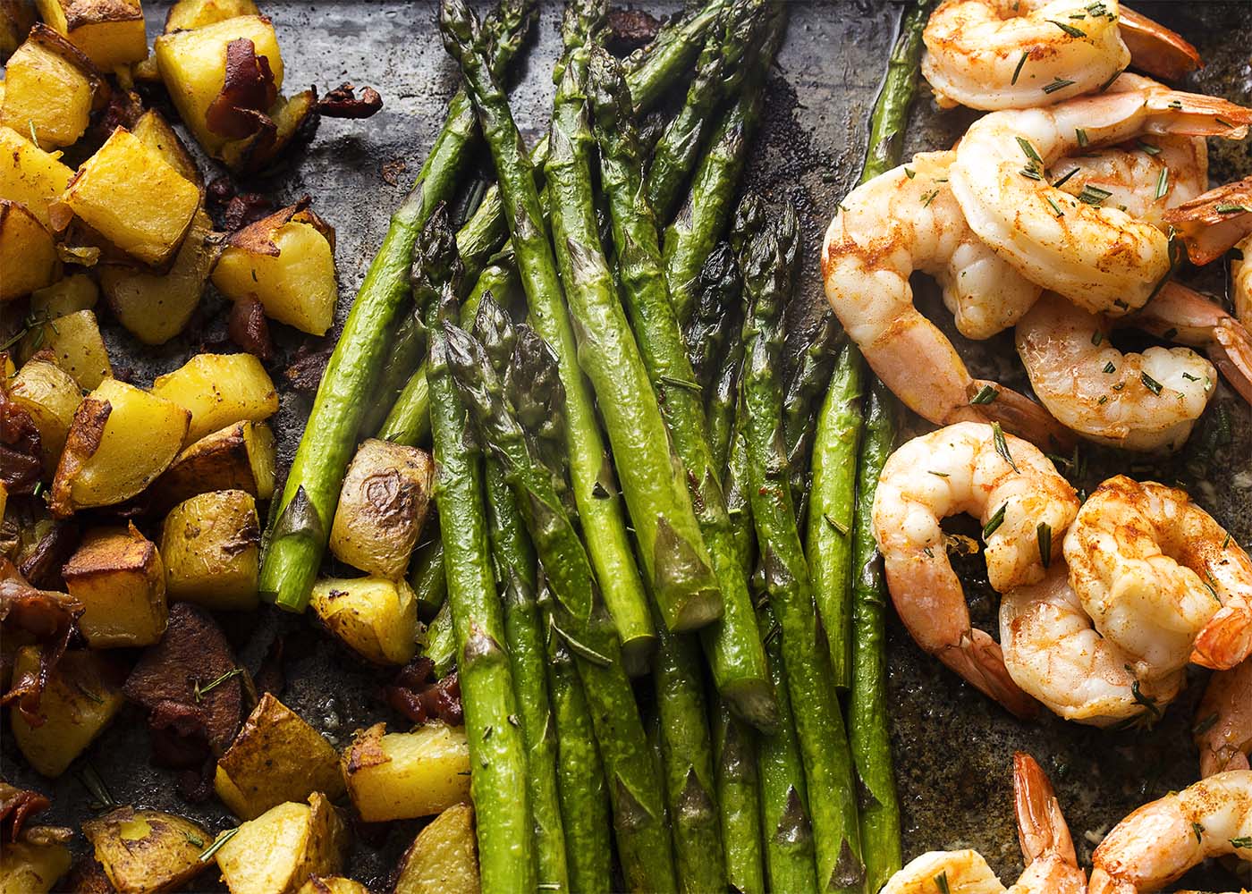 Healthy and easy! This roasted shrimp, asparagus, and potato sheet pan dinner will have food on the table in no time, but without a pile of pots to wash. | justalittlebitofbacon.com