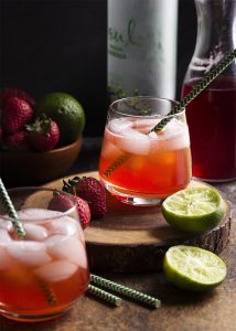 Homemade strawberry syrup topped with ginger beer makes this Brazilian strawberry caipirinha cocktail a refreshingly fruity fizzy drink perfect for summer! | justalittlebitofbacon.com