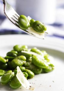 One great way to enjoy fava beans is in this healthy spring inspired fresh fava bean and parmesan salad, which is tossed lightly with a little olive oil and sprinkled with salt and pepper. Simple, but oh so good! | justalittlebitofbacon.com