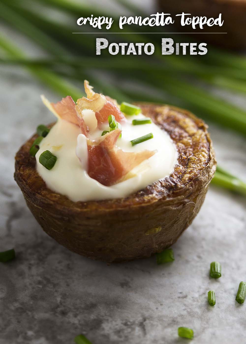 These loaded potato bites make a tasty appetizer for your next party! They are boiled and baked in the oven for extra crispiness and then topped with creme fraiche, pancetta (or bacon!) and chives. Gluten-free, easy, finger food! | justalittlebitofbacon.com