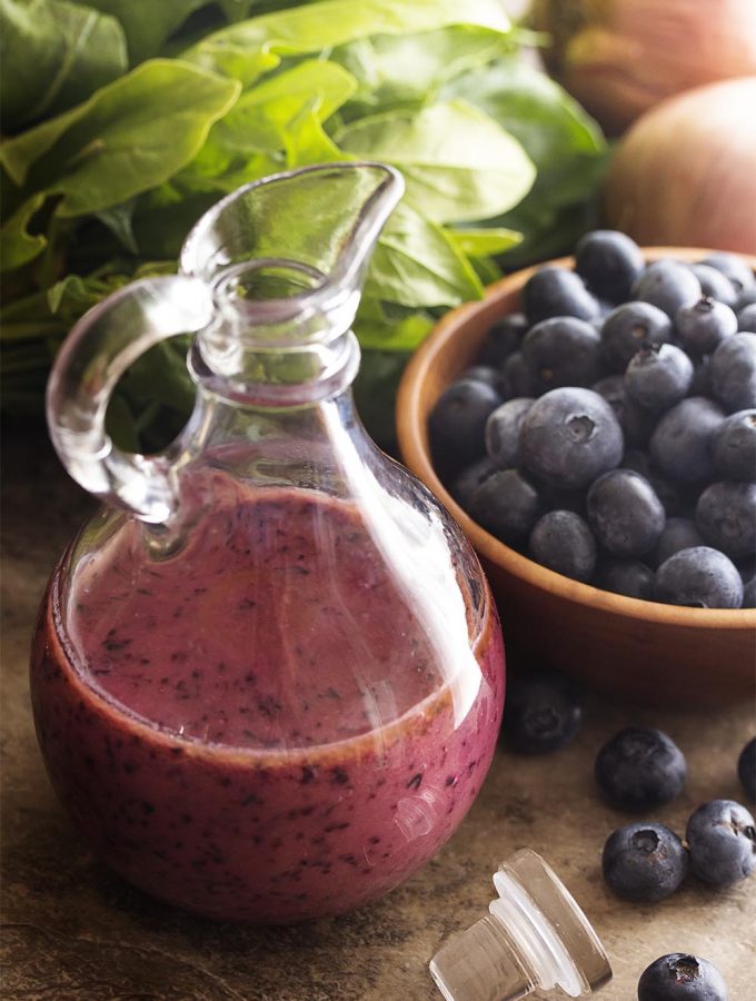 It's time to make a fruity summer salad dressing! Quickly puree up fresh blueberries into a spicy, sweet, and tangy blueberry vinaigrette. | justalittlebitofbacon.com