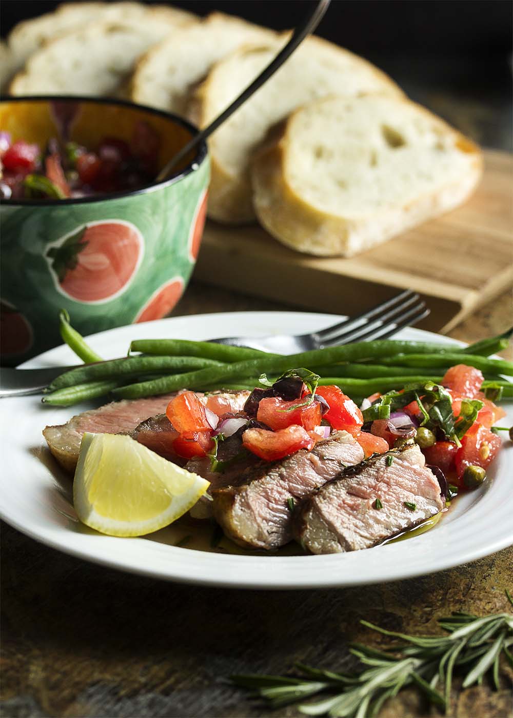 Grilled Tuscan steak is a simple, yet elegant Florentine style specialty! Start with a couple of thick-cut, bone-in steaks, add fresh herbs and a hot grill, then finish them off with fruity olive oil and a squeeze of lemon. | justalittlebitofbacon.com