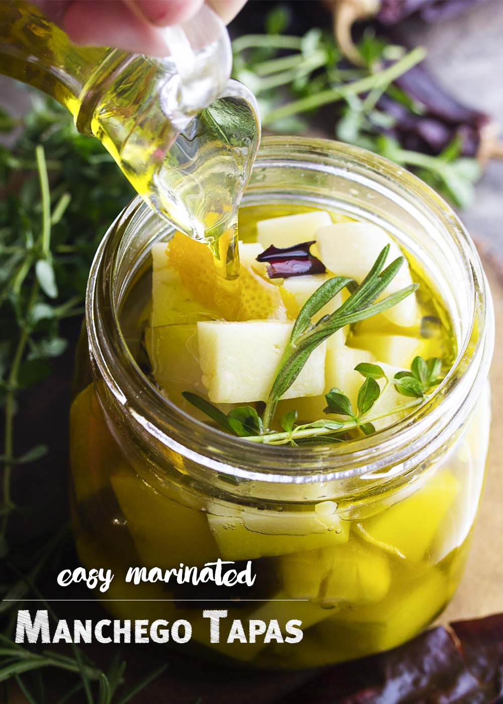 Cubes of Spanish manchego cheese is marinated in a mixture of hot peppers, olive oil, and herbs in this easy manchego tapas recipe. | justalittlebitofbacon.com