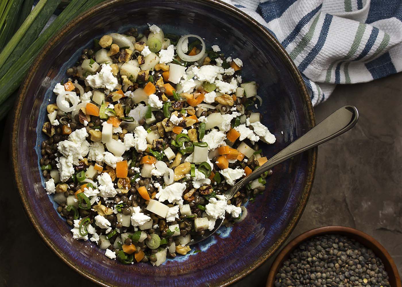 This cold French lentil and kohlrabi salad makes a great summer recipe! The spicy kohlrabi and earthy lentils are tossed with carrots and goat cheese for a tasty weeknight side dish. Healthy, easy, and quick! | justalittlebitofbacon.com