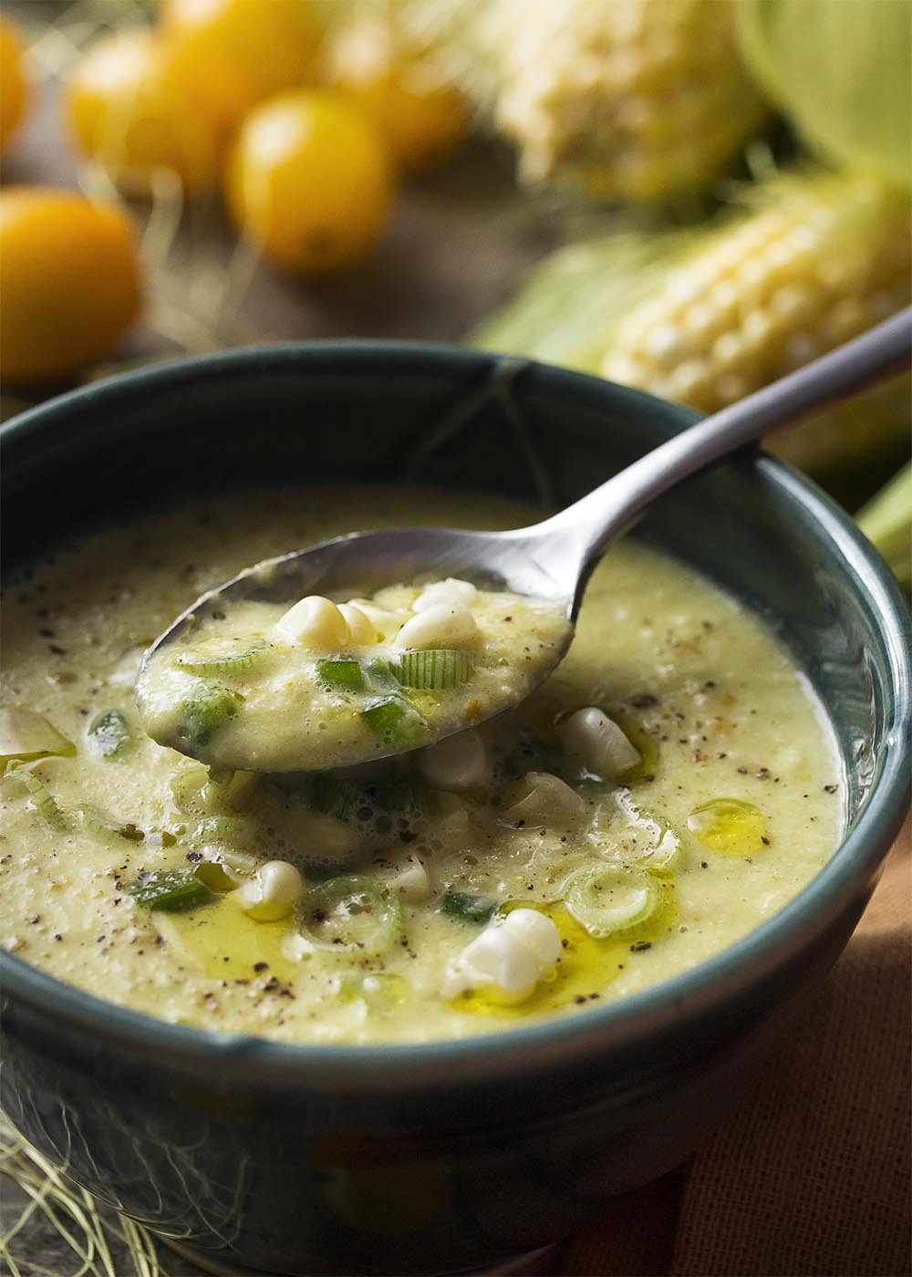 Corn gazpacho is a sweet and spicy cold soup which is refreshing for summer! Easy and quick, it's full of fresh corn, yellow tomatoes, and spicy peppers. | justalittlebitofbacon.com