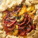 This savory tomato galette is a rustic tart in the French tradition, full of juicy, sweet heirloom tomatoes and creamy goat cheese and then folded into a simple pastry crust. | justalittlebitofbacon.com