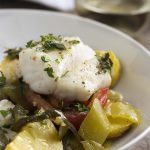 Baked Mediterranean cod is a one dish meal that's big on flavor and easy on cleanup! Thick cut cod is flavored with olive oil and fresh herbs and baked over a bed of mixed vegetables in this simple oven dinner. | justalittlebitofbacon.com