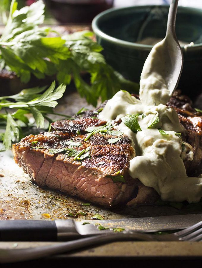 This Spanish inspired grilled ribeye steak is rubbed with paprika and smoked paprika and then topped with a blue cheese brandy sauce for an easy and flavorful main course. | justalittlebitofbacon.com