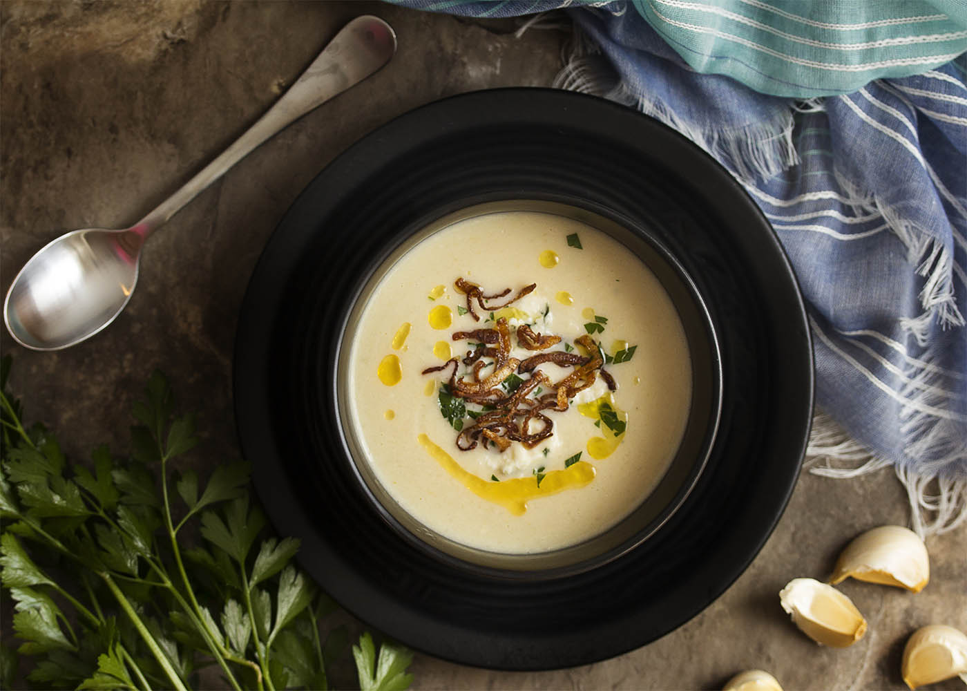 This smooth and creamy cauliflower soup is swirled with blue cheese and topped with truffle oil for great comfort food on a chilly day! | justalittlebitofbacon.com