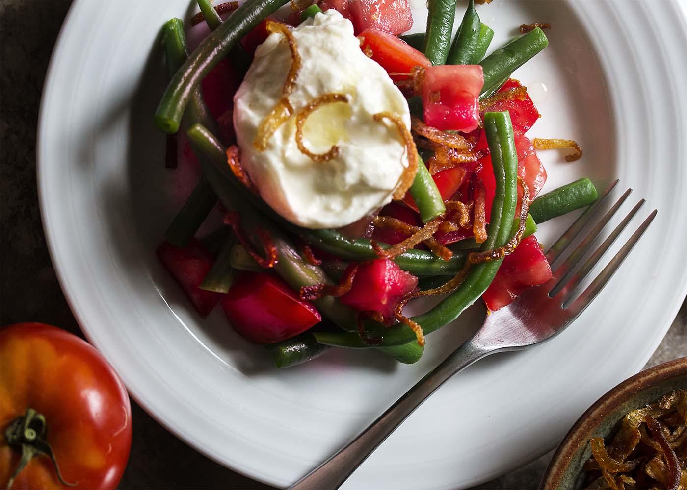 Creamy burrata, crispy shallots and ripe tomatoes along with fresh green beans give my Italian green bean salad plenty of flavor and balance. Add in a homemade Italian dressing and you'll want to make this salad every week! | justalittlebitofbacon.com