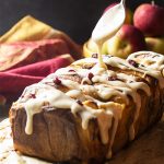 Apple pie filling and bourbon soaked cranberries are sandwiched in between layers of rich bread dough in this apple pull apart bread. | justalittlebitofbacon.com